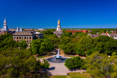 Baylor Pat Nef and skyline behind a flowing fountain on a sunny day